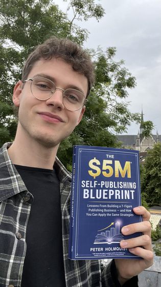 A new publisher holding The Self-Publishing Blueprint